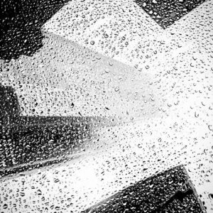 rain on a window of a city by denise nassar