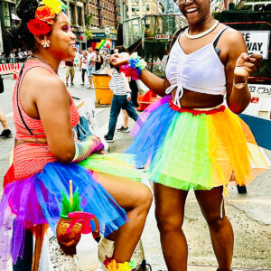two black females wearing colorful outfits in the streets